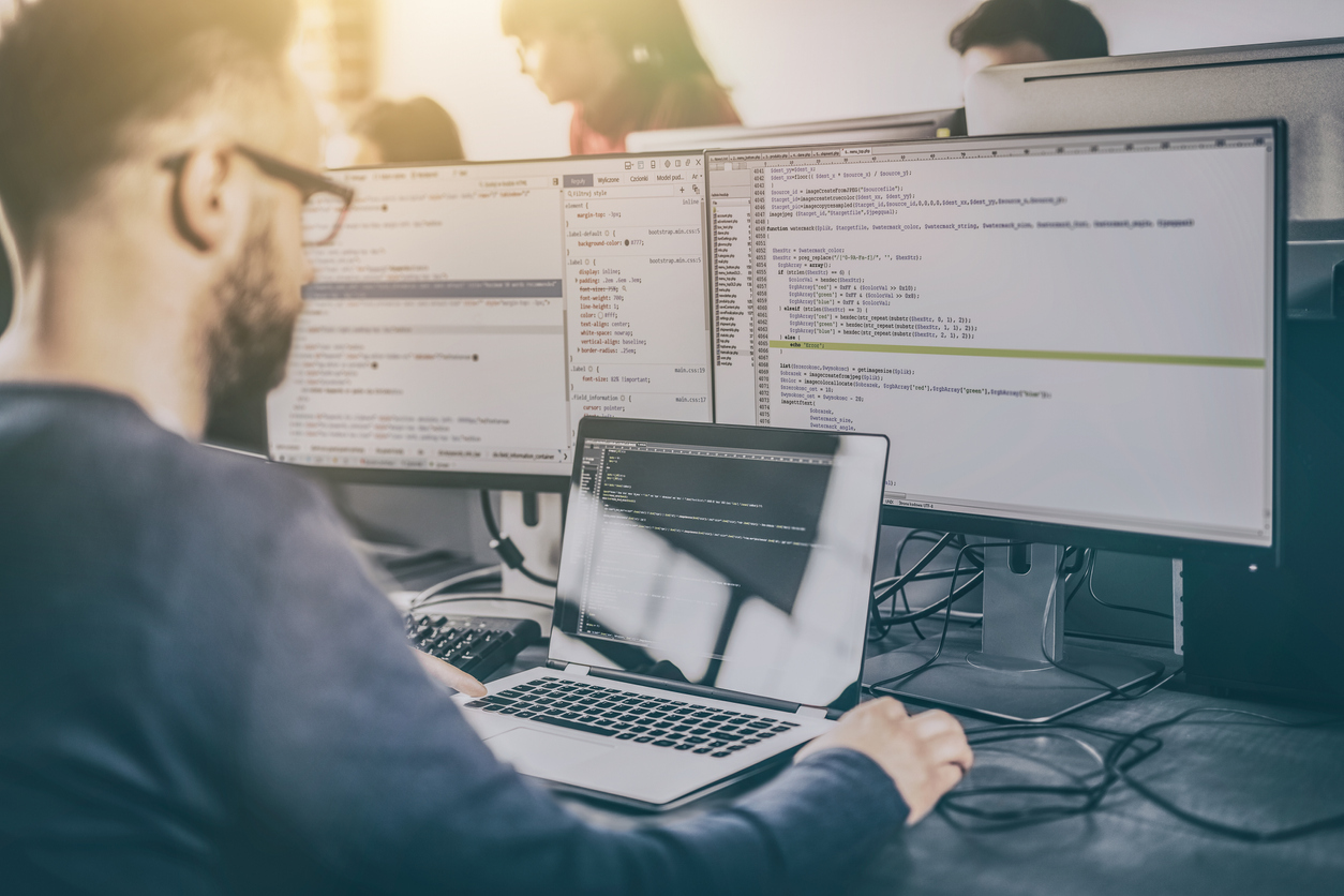 man working on it servers with laptop in hand